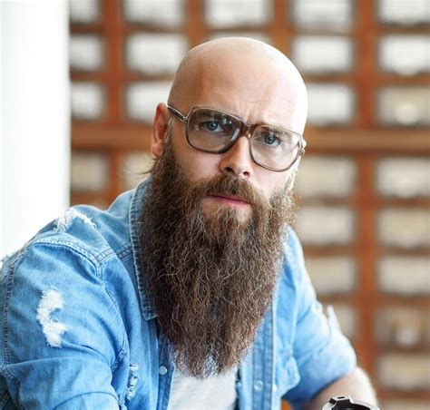 bald bearded man with glasses.